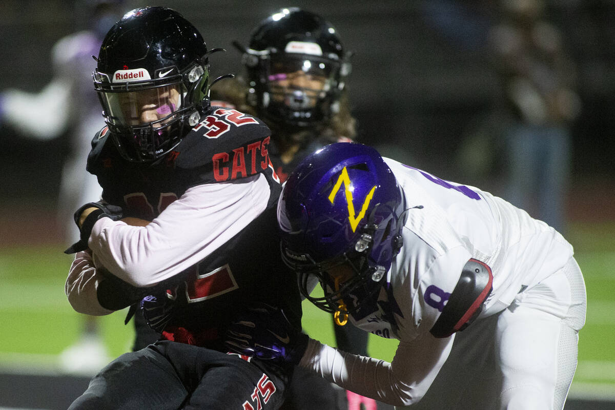 Las Vegas' defensive back Camden Bradshaw (32) catches an interception in the endzone while Dur ...