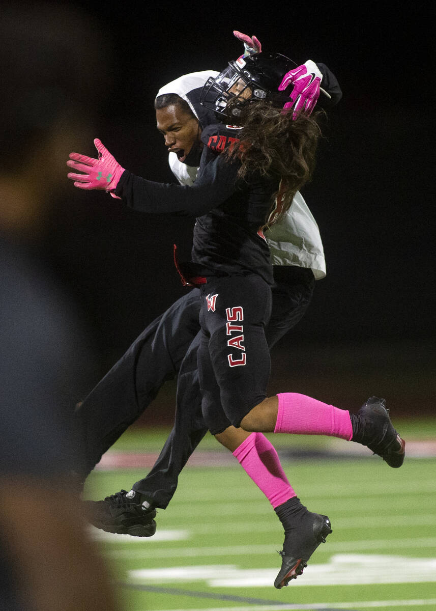 Las Vegas' Kawika Lopez (8) jumps with a teammate to celebrate the interception he caught durin ...