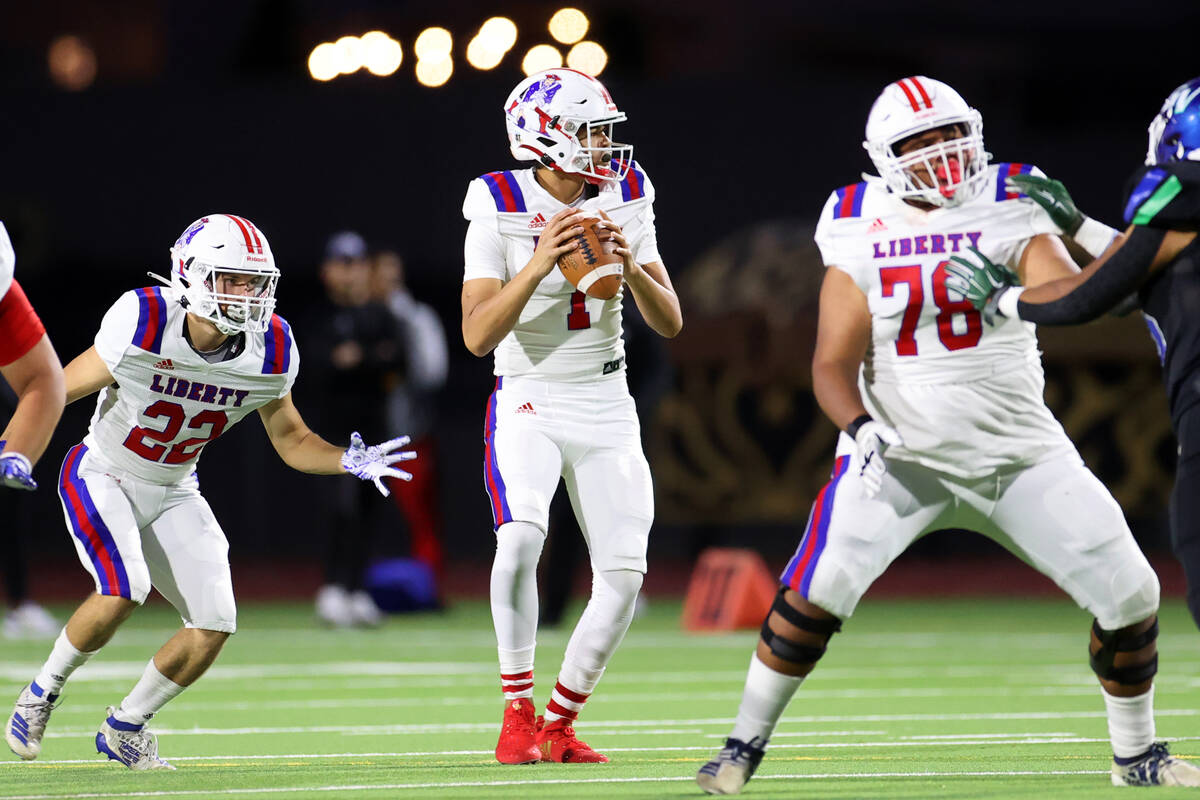 Liberty's Jayden Maiava (1) looks for an open pass in the first half of a football game against ...