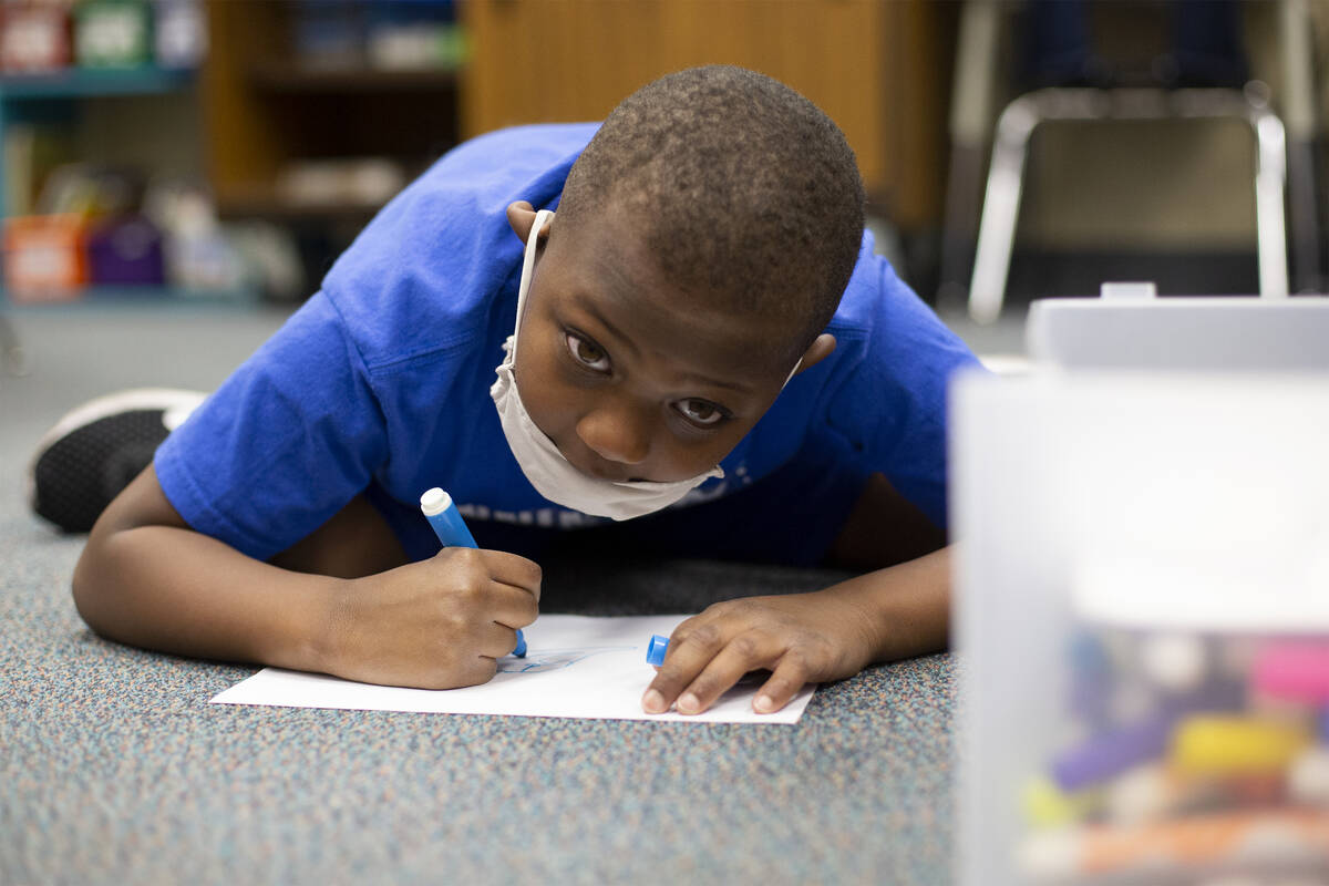 First grader Miles Strauss takes a coloring break during his schoolday at Charlotte Hill Elemen ...