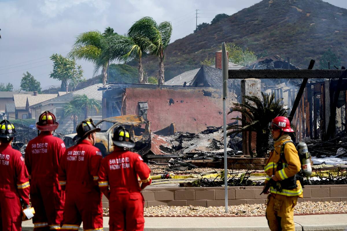 Fire crews work the scene of a small plane crash, Monday, Oct. 11, 2021, in Santee, Calif. (AP ...