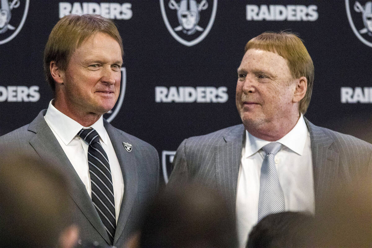 Jon Gruden, left, after being announced as the head coach of the Oakland Raiders with owner Mar ...