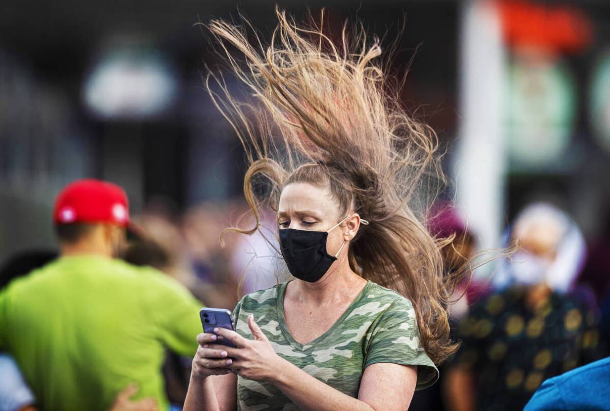 People brave high winds on the Strip on Monday, Oct. 11, 2021, in Las Vegas. (Benjamin Hager/La ...