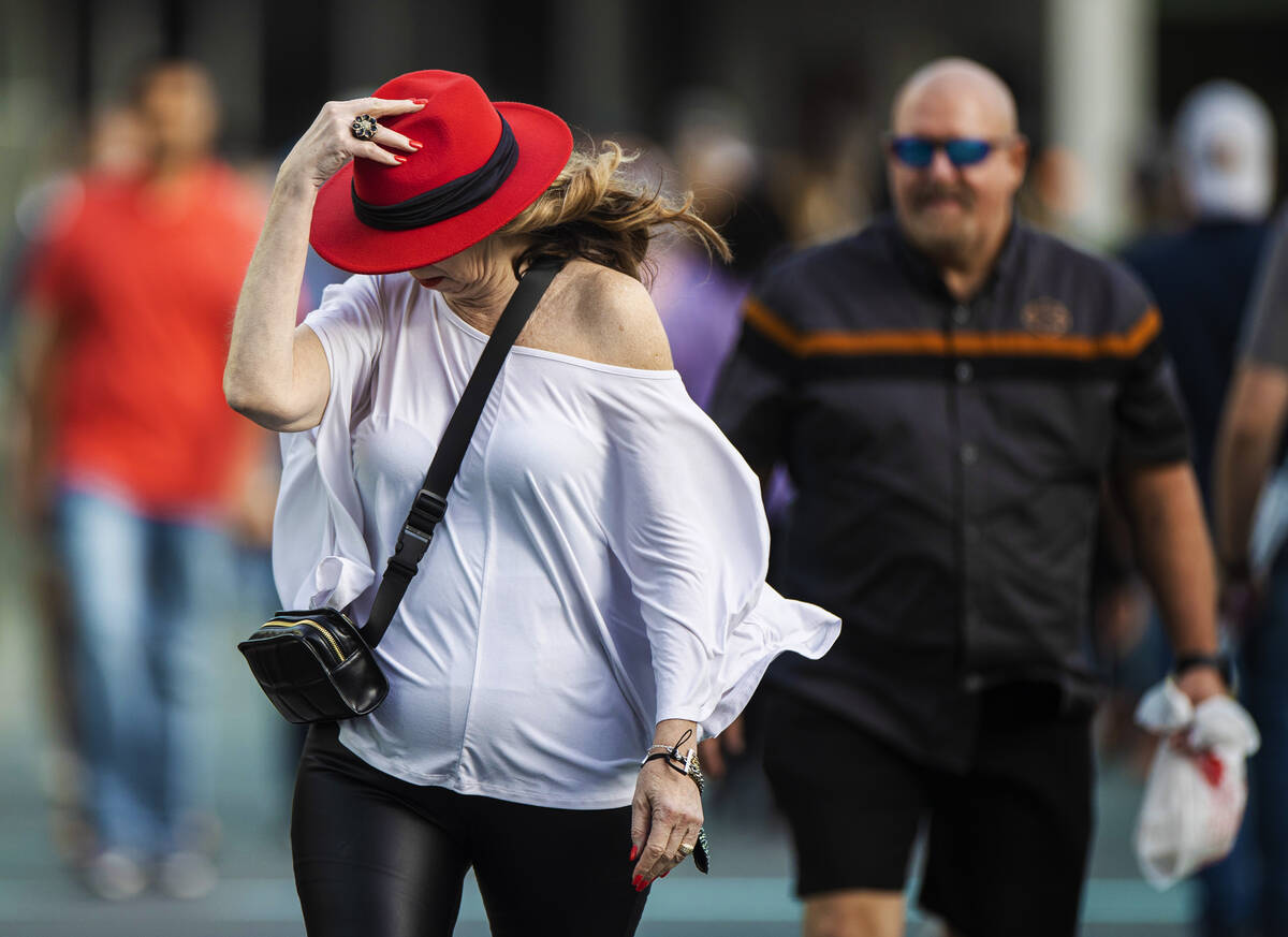 People brave high winds on the Strip on Monday, Oct. 11, 2021, in Las Vegas. (Benjamin Hager/La ...