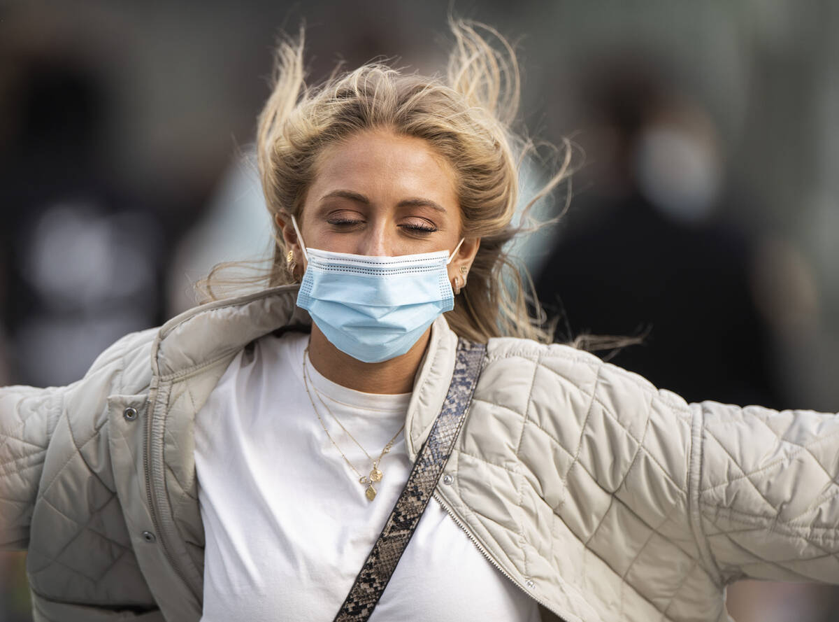 People brave high winds on the Strip on Monday, Oct. 11, 2021, in Las Vegas. (Benjamin Hager/La ...