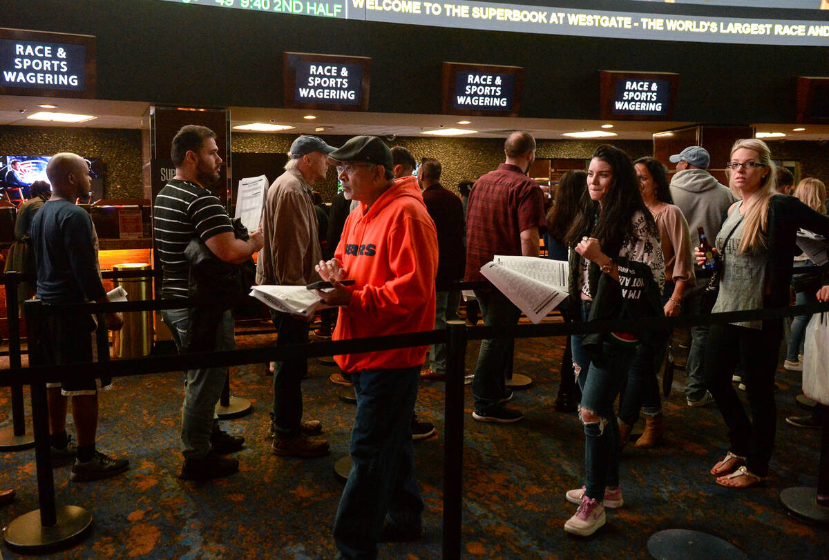 Bettors line up to place prop bets for the Super Bowl at the Westgate Superbook in Las Vegas in ...