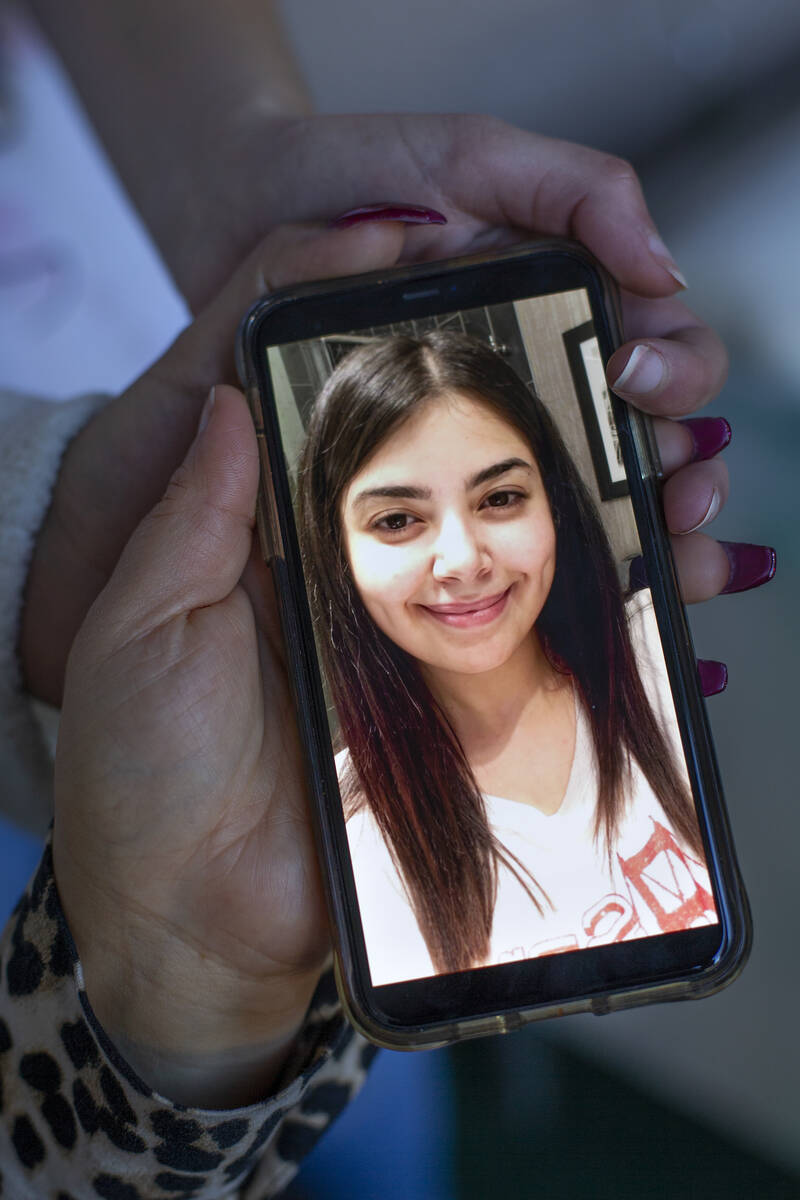 Jawaher Hejji's mother and two sisters Mariam Hejji and Rowda Hejji hold a photo of her at Mari ...