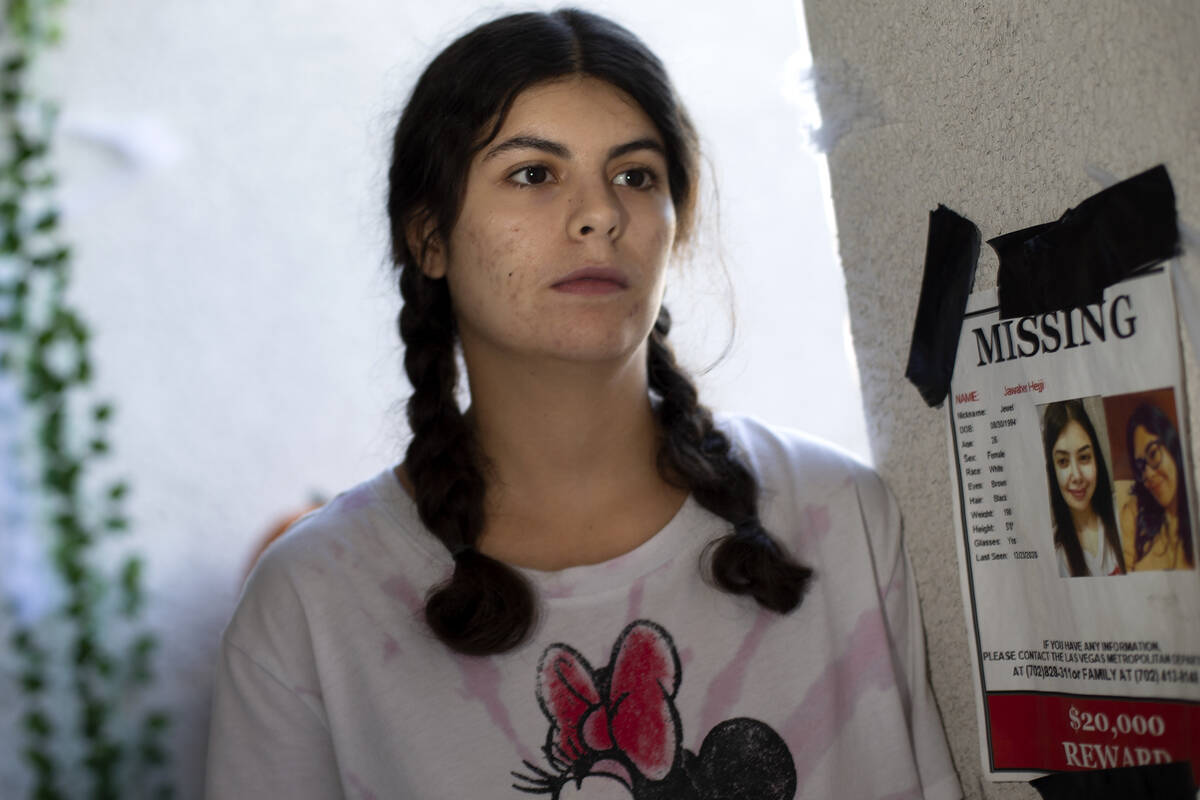 Mariam Hejji, the younger sister of Jawaher Hejji, poses next to the missing flyer for her sist ...