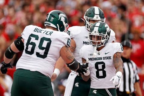 Michigan State wide receiver Jalen Nailor (8) is congratulated by Blake Bueter (69) after scori ...