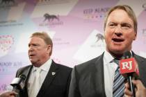 Raiders head coach Jon Gruden, right, and Raiders owner Mark Davis talk with the media on the r ...