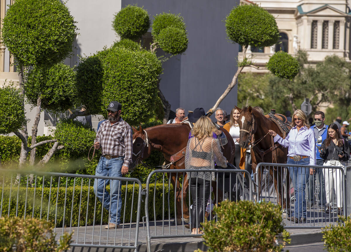Cowboys Shane Hancheym and Sage Kimzey arrive with horses and their crew to make the rounds at ...