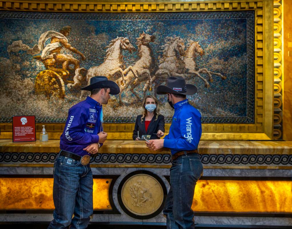 Cowboys Shane Hanchey (left) and Sage Kimzey, right, check in at Caesars Palace to promote the ...
