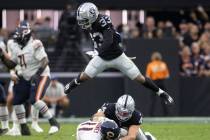 Raiders safety Roderic Teamer (33) leaps over Raiders inside linebacker Nick Kwiatkoski (44) an ...