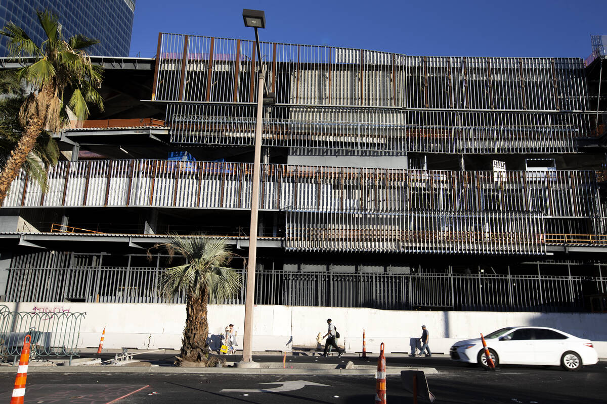 Pedestrians and traffic pass the unfinished former Fontainebleau building on Thursday, Oct. 14, ...