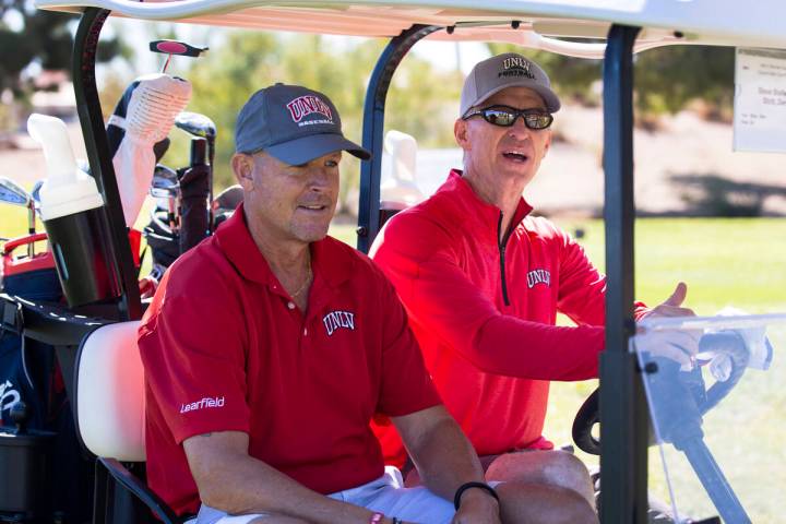 Former UNLV starting quarterbacks Derek Stott, left, and Steve Stallworth get to ride in a cart ...