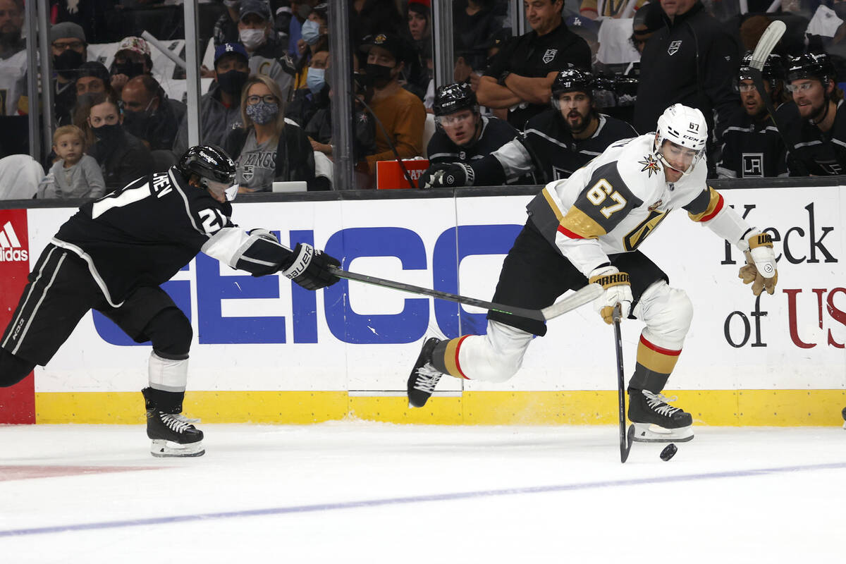 Los Angeles Kings forward Vladimir Tkachev (21) tries to slow Vegas Golden Knights forward Max ...