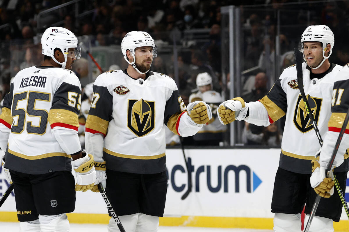 Vegas Golden Knights defenseman Shea Theodore, center, celebrates his goal against the Los Ange ...