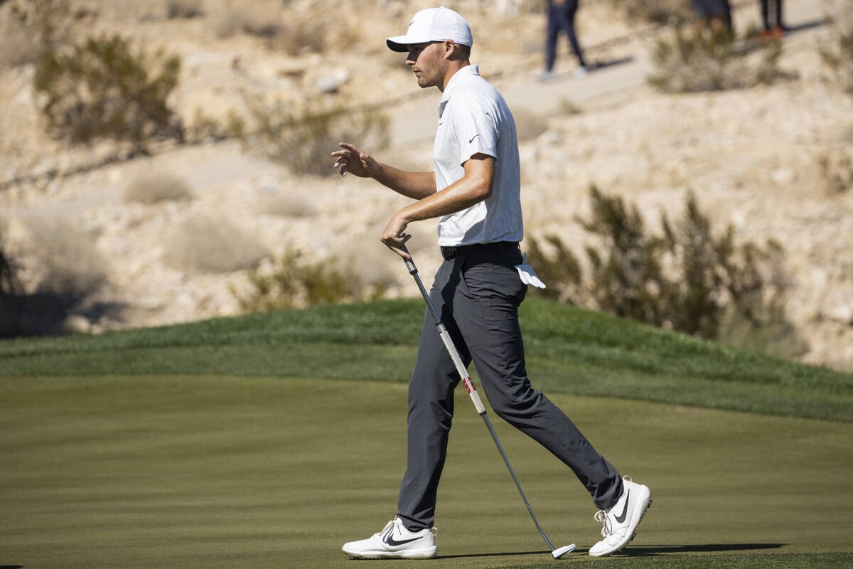 Aaron Wise raises his hand after putting for a birdie in the 17th hole during the first round o ...