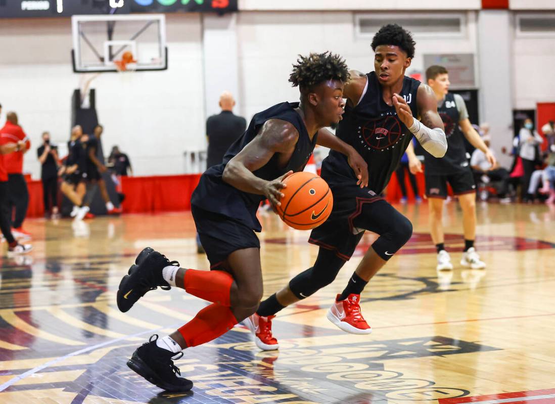 UNLVÕs Michael Nuga (1) drives to the basket against Keshon Gilbert (10) during an open ba ...