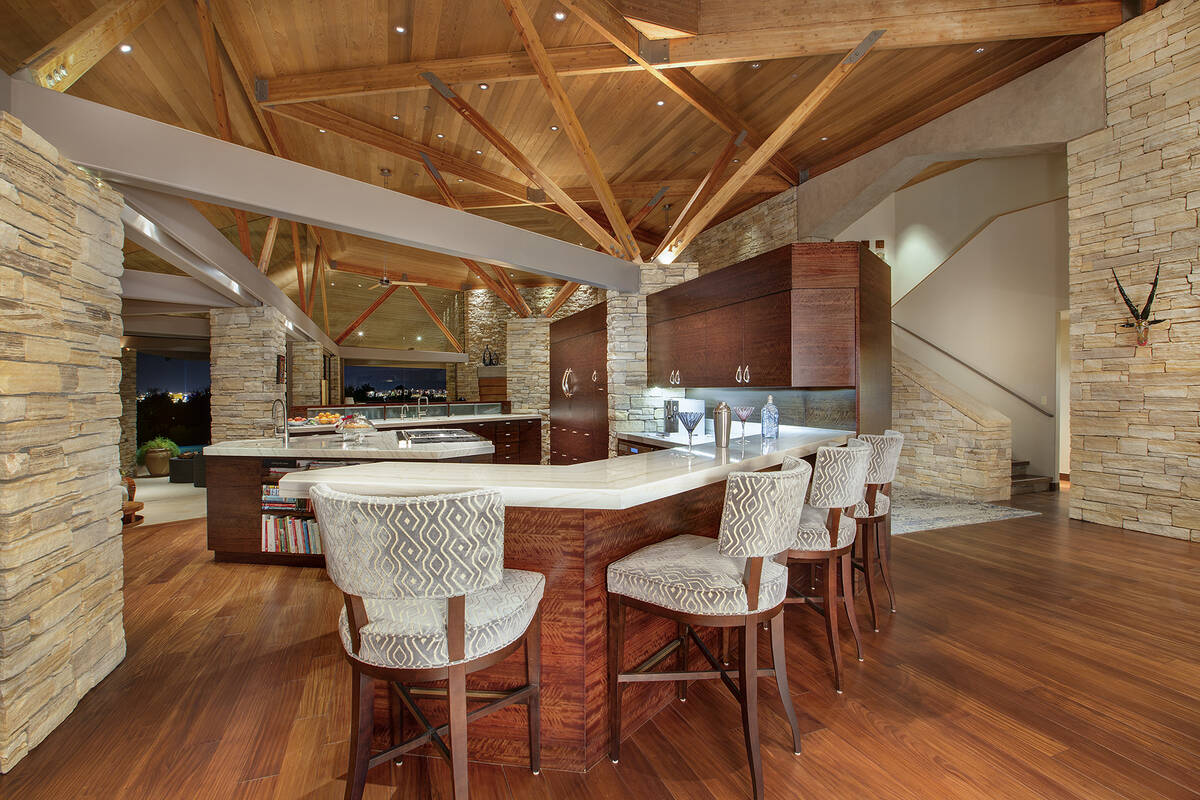 The main house features a formal living room, dining area with three fireplaces, a chef’s gra ...