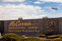 A sign for McCarran International Airport with a plane taking off above it at Tropicana Avenue ...