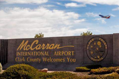 A sign for McCarran International Airport with a plane taking off above it at Tropicana Avenue ...