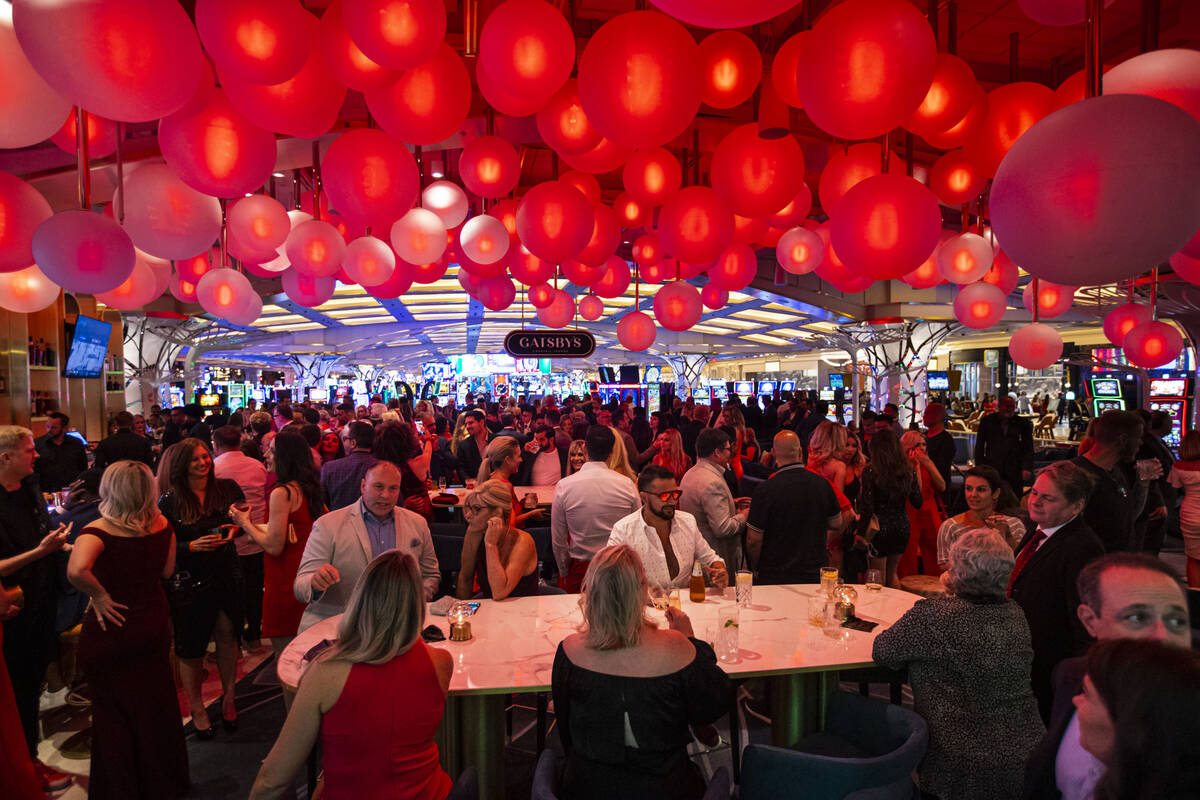 People drink and mingle at Gatsby's cocktail lounge during the opening night of Resorts World L ...