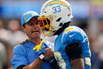 Los Angeles Chargers head coach Brandon Staley talks to free safety Derwin James (33) before an ...