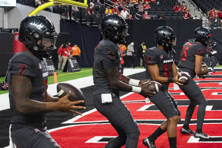 UNLV Rebel's quarterbacks Cameron Friel (7) Justin Rogers (5) Jared Heywood (14) and Matthew Ge ...