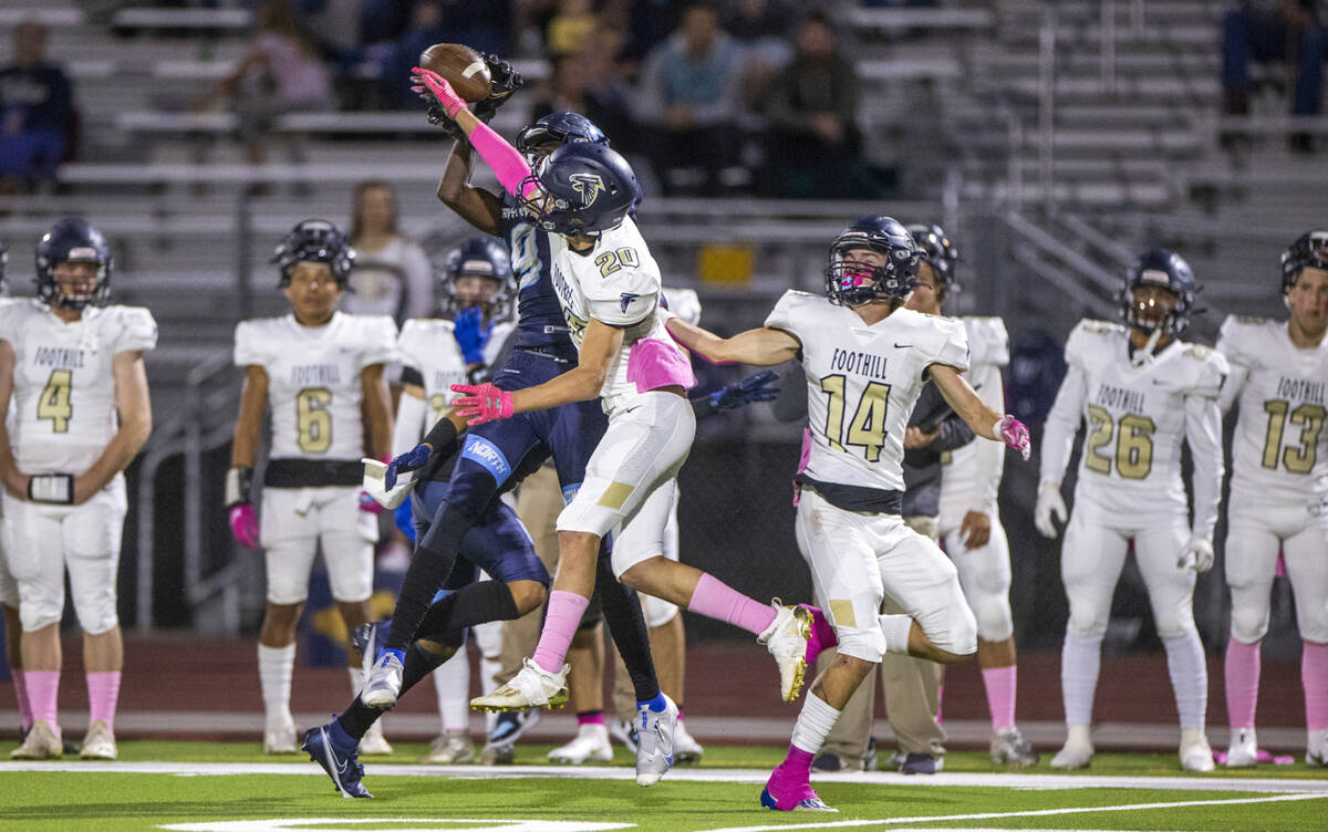 Canyon SpringsÕ Tavian A. McNair (9, left) has a pass knocked away by FoothillÕs Jaso ...