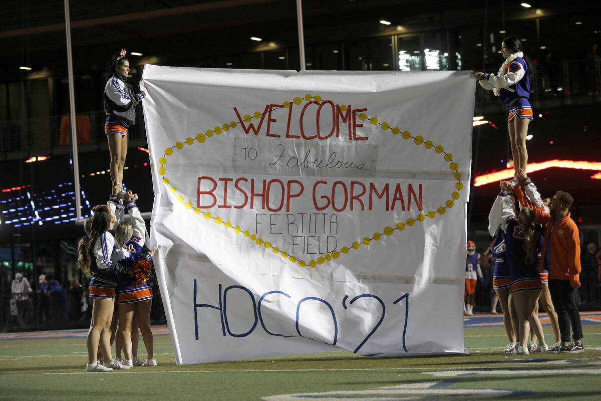 Bishop Gorman High School's cheerleaders hold a banner before the second half of a football gam ...