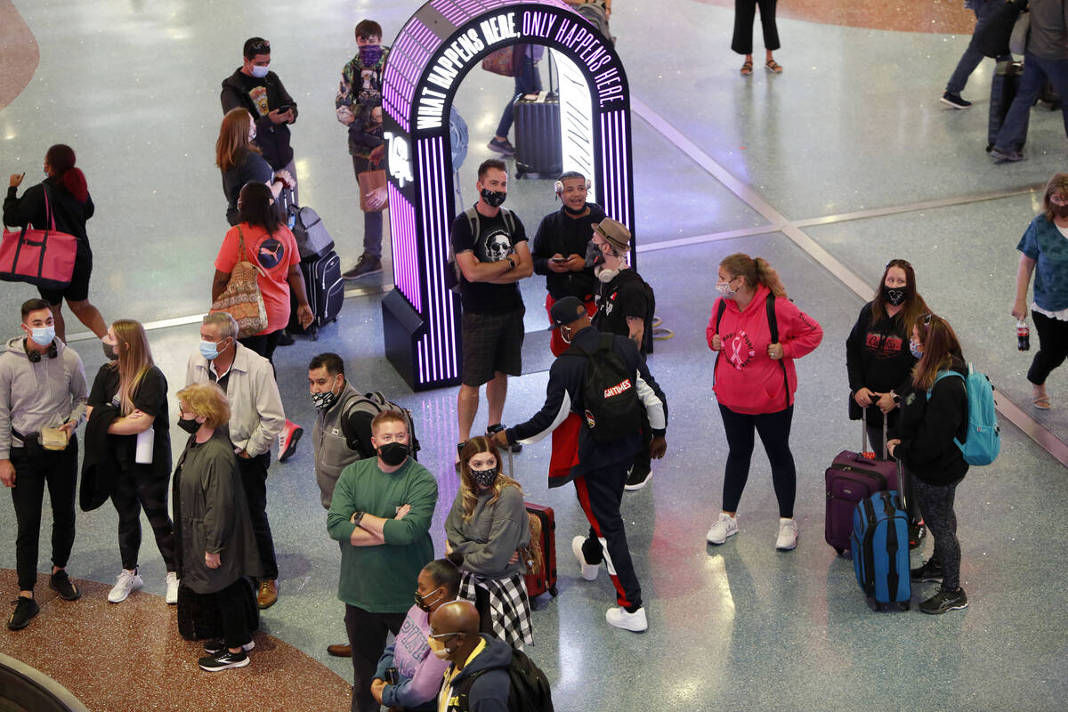 Arriving passengers await their bags in the baggage claim area of McCarran International Airpor ...