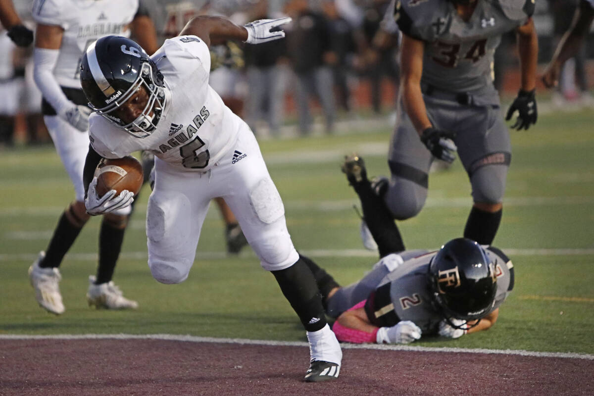 Desert Pines High School's Ferrari Busby (6) scores a touchdown over Faith Lutheran School's Ja ...