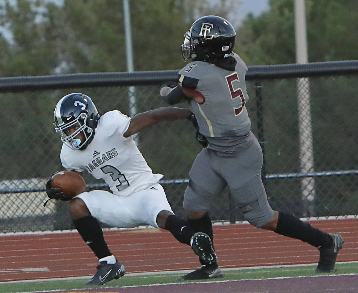 Desert Pines High School's Lavon Brown (3) scores a touchdown over Faith Lutheran School's Jord ...