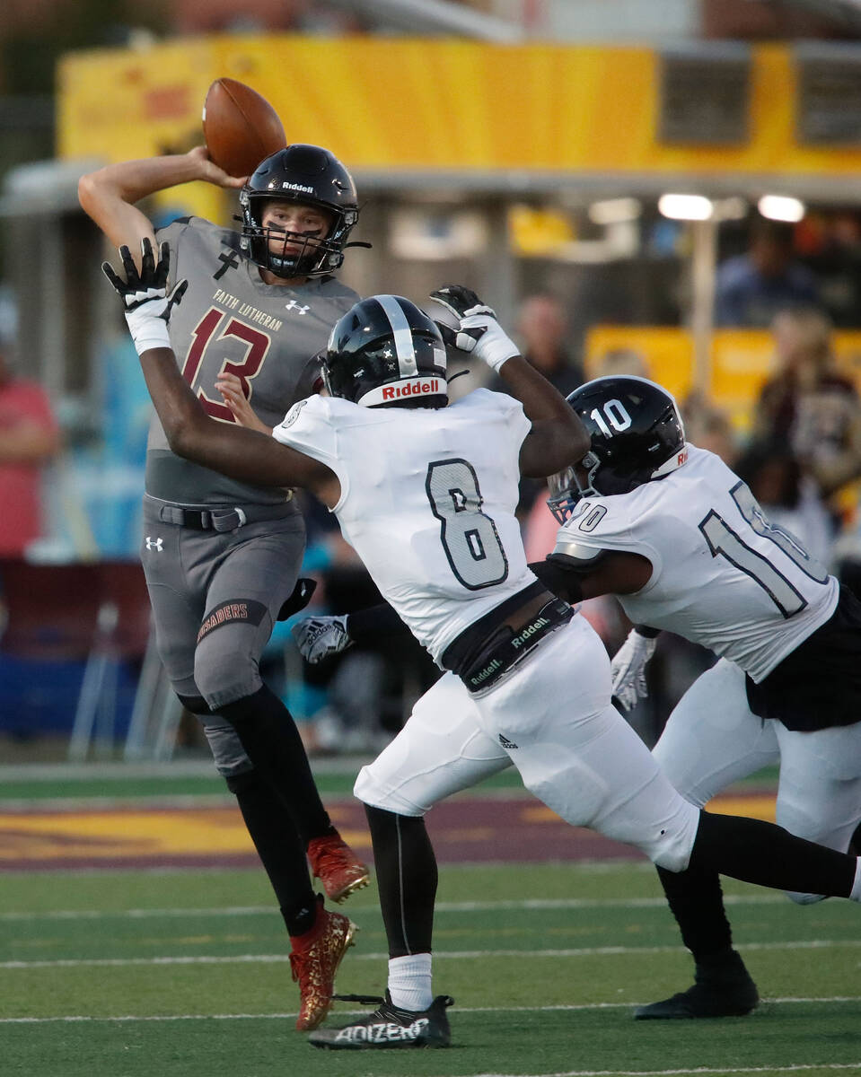 Faith Lutheran School's Rylan Walter throws a pass against Desert Pines High School's Labarrio ...