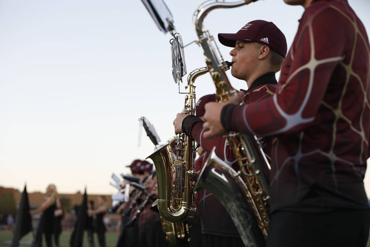 Faith Lutheran School's marching band performs before a football game against Desert Pines High ...