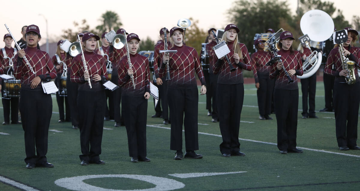Faith Lutheran School's marching band performs before a football game against Desert Pines High ...
