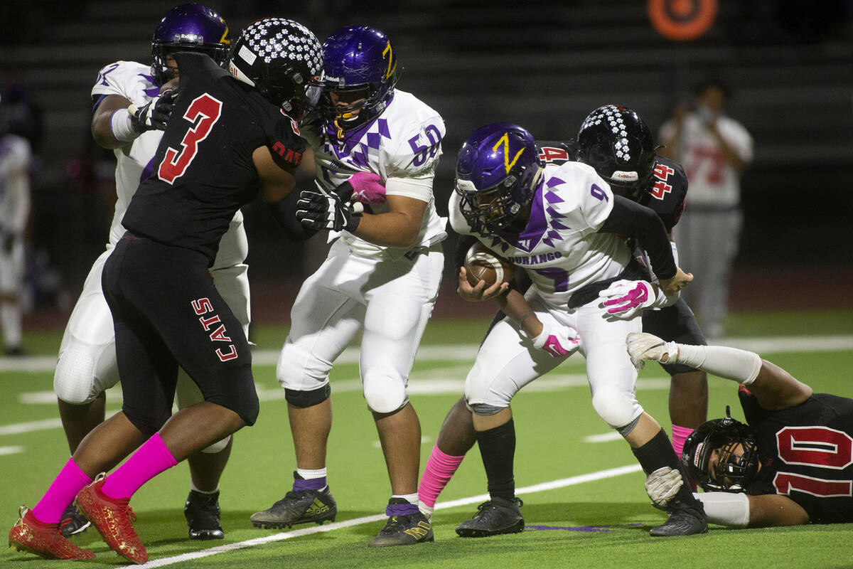 Las Vegas' defensive lineman Josue Santos (10) and left back Rob Flanagan (44) take down Durang ...