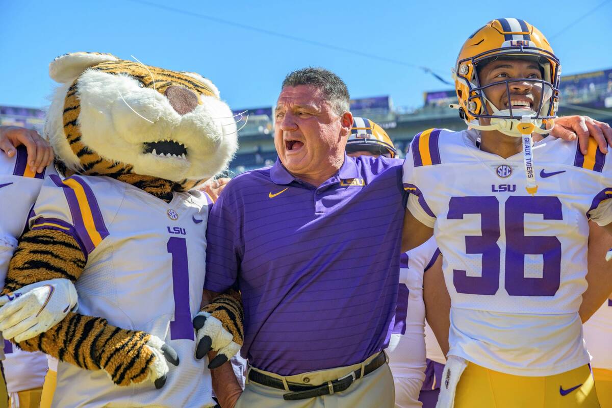 LSU head coach Ed Orgeron celebrates his team's 49-42 victory against Florida in an NCAA colleg ...