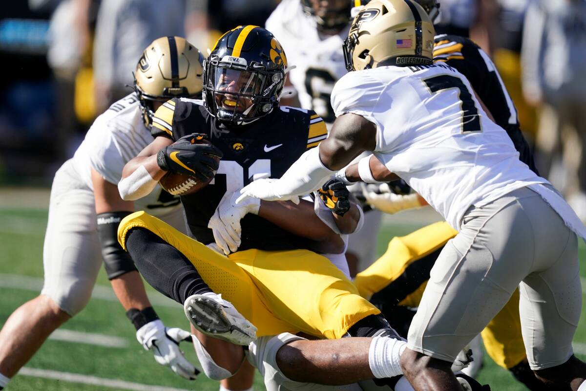 Iowa running back Ivory Kelly-Martin (21) is tackled by Purdue cornerback Jamari Brown (7) duri ...