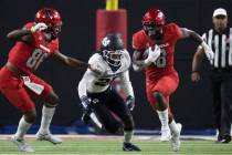 Rebels running back Charles Williams (8) sprints up field past Utah State Aggies safety Monte' ...