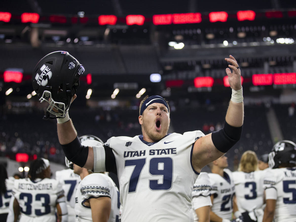 Utah State Aggies offensive lineman Wade Meacham (79) celebrates after beating UNLV at the end ...