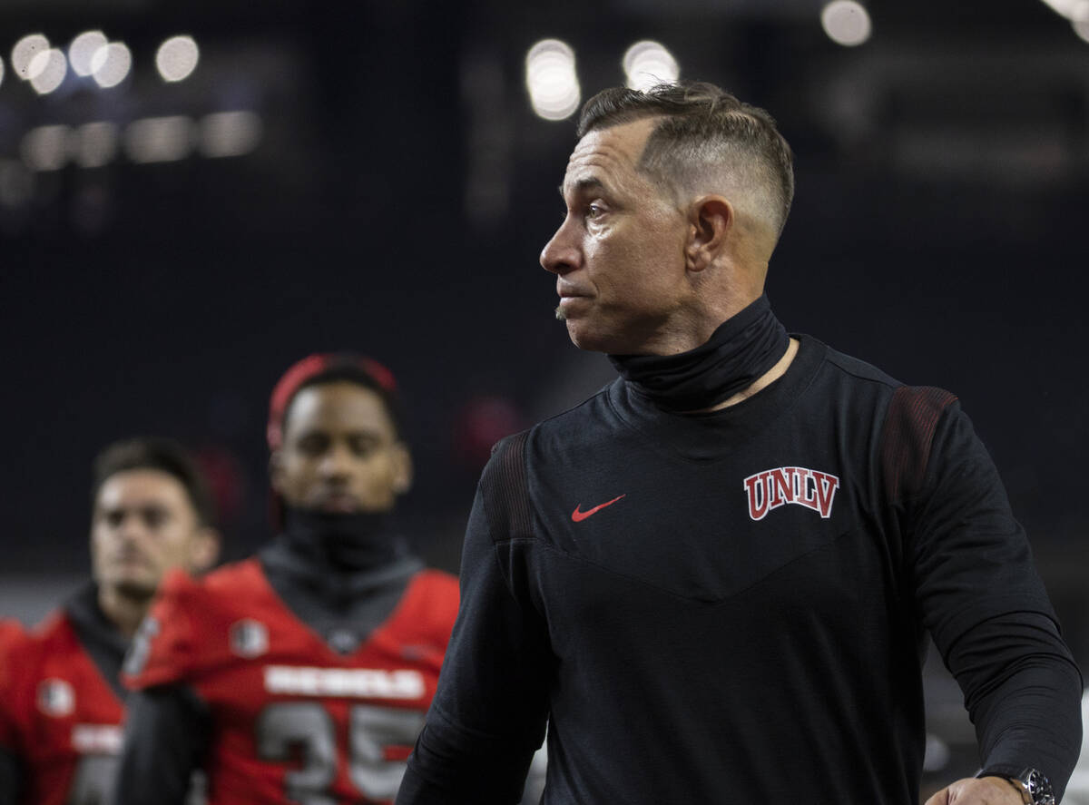 UNLV Rebels head coach Marcus Arroyo walks off the field after losing to Utah State at the end ...