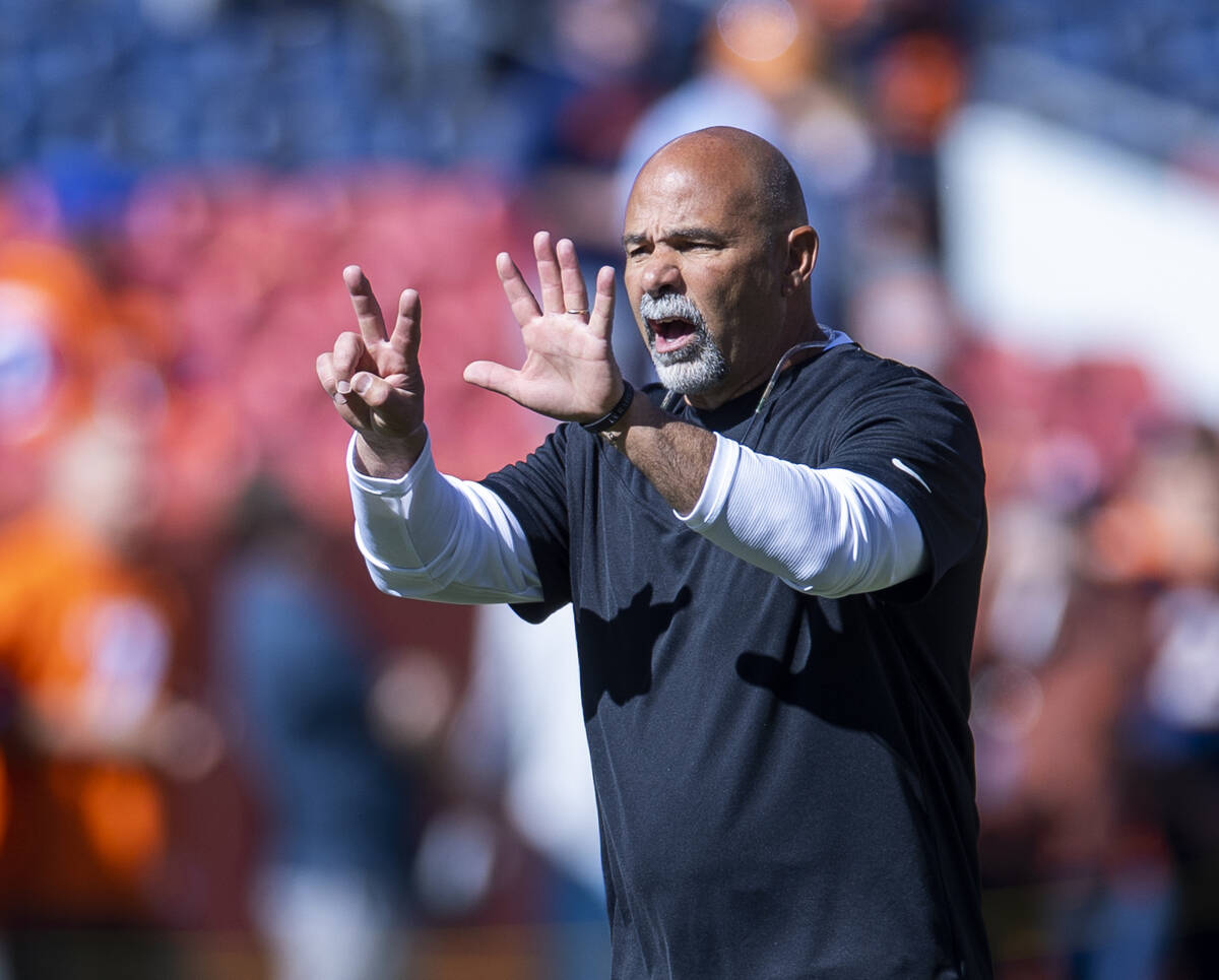 Raiders interim head coach Rich Bisaccia signals a player before the first half of an NFL game ...