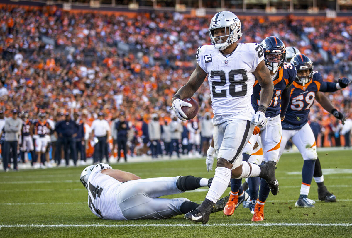 Raiders' running back Josh Jacobs (28) eases into the end zone over the Denver Broncos during t ...