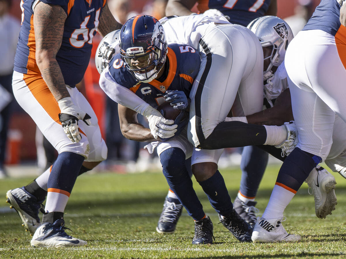 Denver Broncos quarterback Teddy Bridgewater (5) is sacked by Raiders' defensive end Maxx Crosb ...
