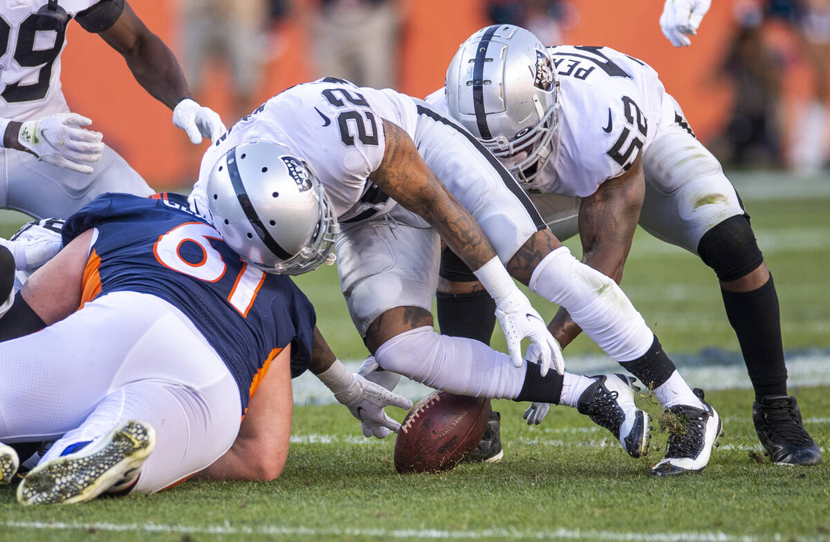Raiders' defensive back Keisean Nixon (22, right) eyes a fumble with teammate middle linebacker ...