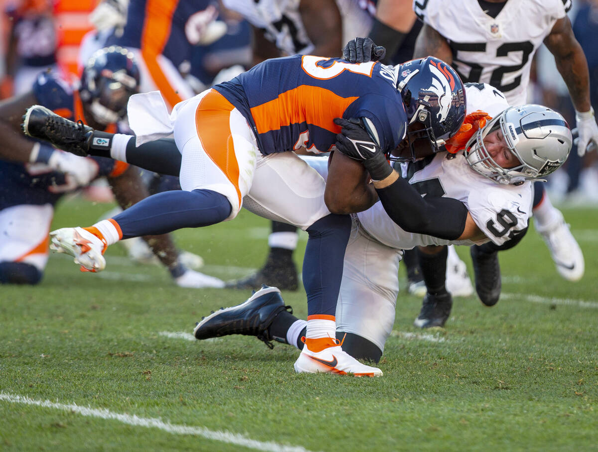 Raiders defensive end Carl Nassib (94) tackles Denver Broncos running back Javonte Williams (33 ...