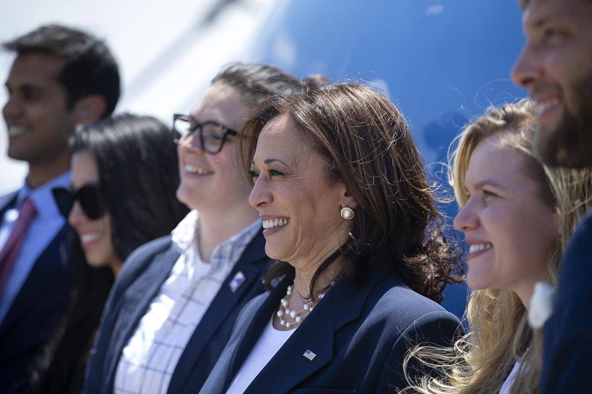 Vice President Kamala Harris poses for a photo with members of her staff before departing at Mc ...