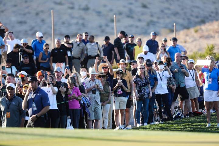 The crowds watch around the eighteenth hole CJ Cup golf tournament at the Summit Club in Las Ve ...